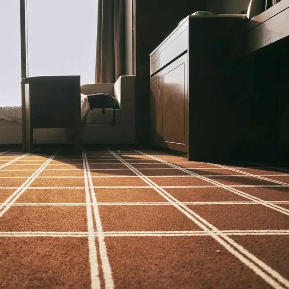 Low view across a checked brown carpet